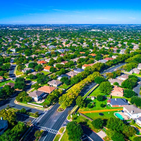 Growing suburban town Round Rock , Texas , USA aerial drone view high above Suburb Neighborhood with Vast amount of Homes